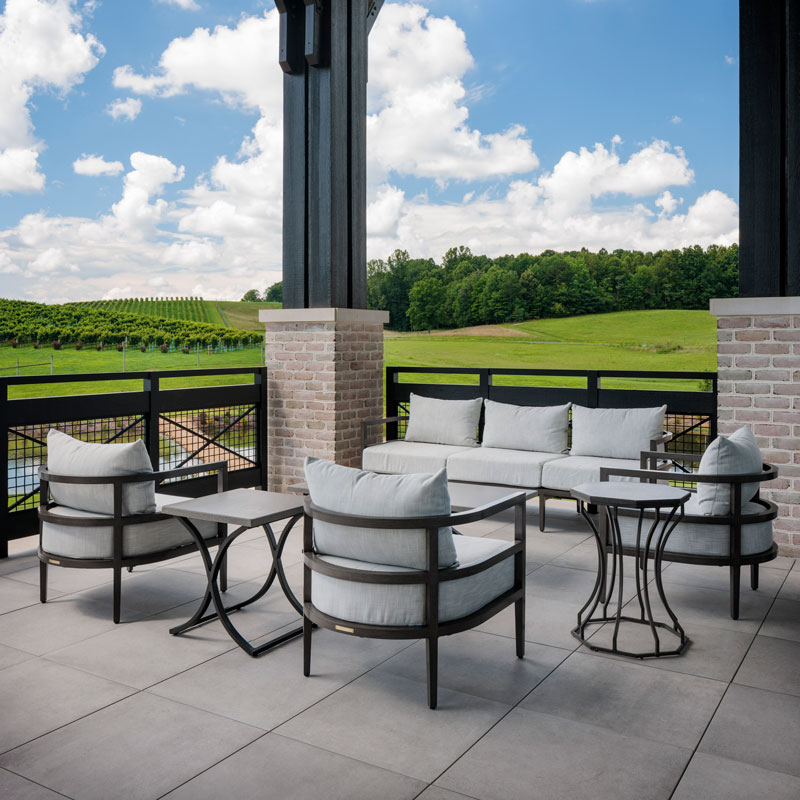 white cushioned patio furniture set overlooking green yard