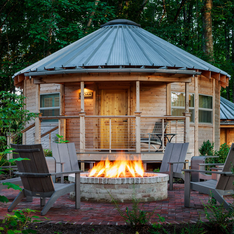 active fire pit outside a yurt